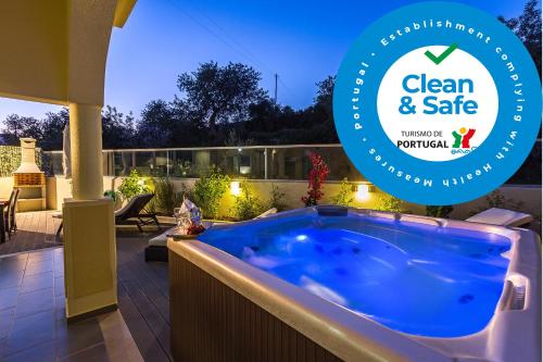a jacuzzi tub in a yard with a patio at D_Loft Sea and Golf in Albufeira