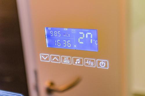 a clock on the side of a refrigerator at Jacuzzi - Flexible SelfCheckIns 20 - Zagreb - Luxury - Garage - Smart - Brand New - Apartments Repinc in Zagreb