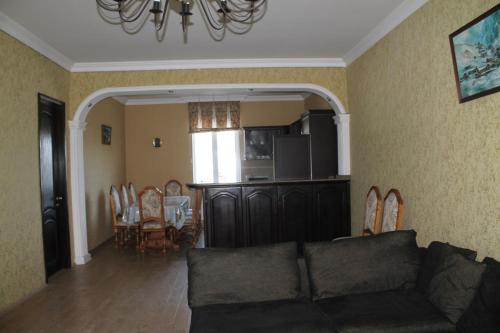 a living room with a couch and a dining room at Hotel Villa Oasis in Kobuleti