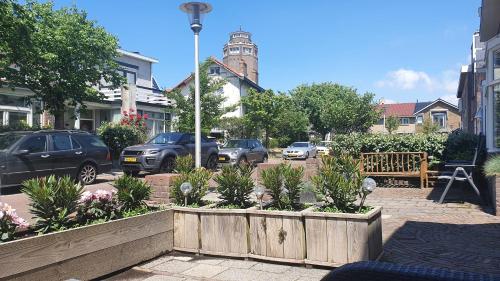 
a street scene with a bench and a flower pot at Guesthouse Zandvoort in Zandvoort
