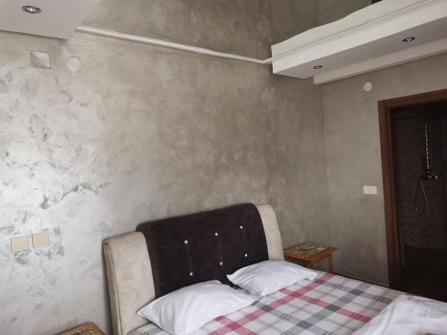 a bedroom with a bed with a checkeredkeredkered at Airport Apartments in Belgrade