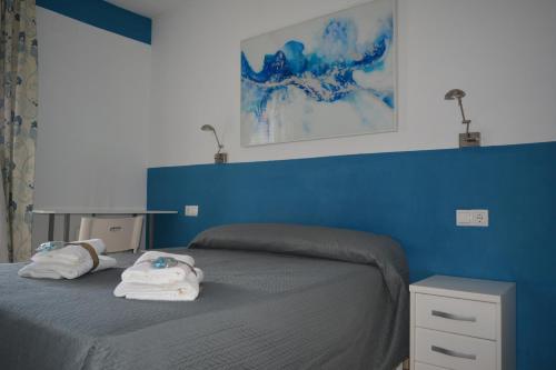 una camera blu con un letto e asciugamani di Alojamiento CAZORLA DELUXE a Cazorla