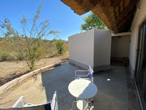 a table and chairs sitting on a patio at Lengau Lodge in Grietjie Nature Reserve