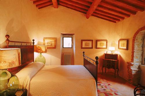 a bedroom with a large bed in a room at Castello di Bibbione in San Casciano in Val di Pesa