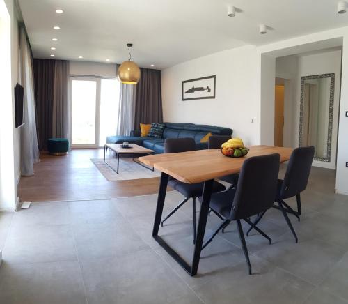 a living room with a table and a blue couch at Sunce in Primošten