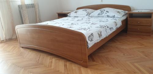 a bed with a wooden frame in a bedroom at Ana Andreskic in Lopar