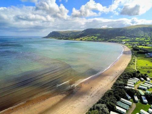 an aerial view of a beach with the ocean at Cullentra House in Cushendall