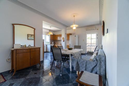a kitchen and dining room with a table and chairs at Paradise residency in Iraklitsa