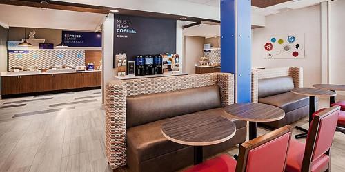 a restaurant with two tables and a counter at Holiday Inn Express & Suites - Kokomo South by IHG in Kokomo
