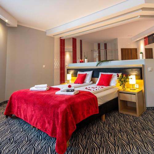 a hotel room with a large bed with a red blanket at Hotel Bardo in Bardo
