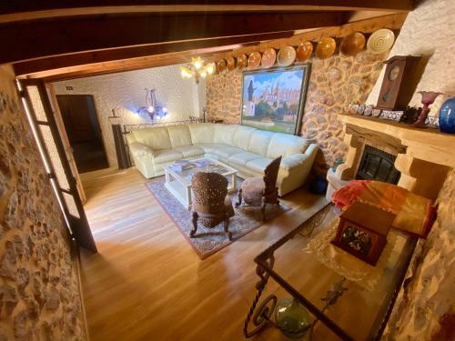 a living room with a couch and a fireplace at Finca Ses Fontanelles in Andratx