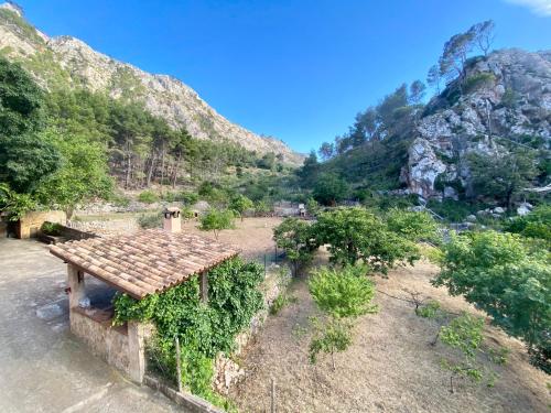 an old building with a mountain in the background at Finca Ses Fontanelles in Andratx