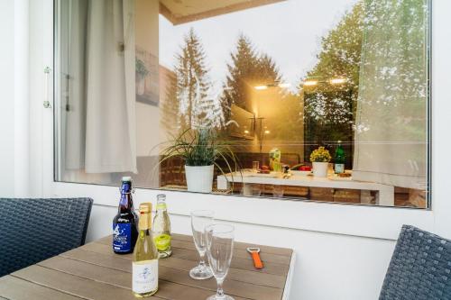 a table with wine bottles and glasses on it at Hexe III in Altenau