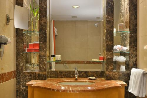 a bathroom with a sink and a mirror at Vivanta Vadodara in Vadodara