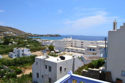 a view of a town with white buildings and the ocean at Studio Ioanna Tinos in Kionia