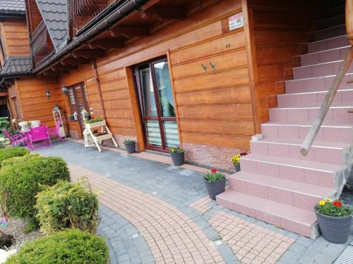 a house with a pink staircase and a patio at Willa u Magdy in Zakopane