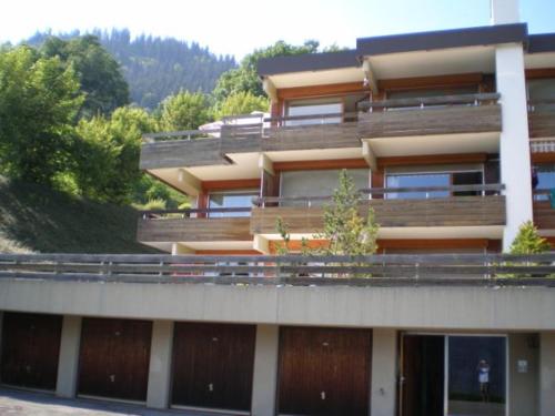a large building with a balcony on the side of it at Roc d'Orsay F66 in Leysin