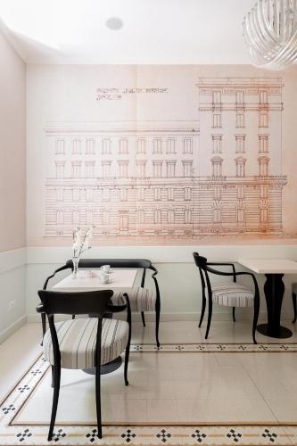 a dining room with two chairs and a table at Queen Meg Roma in Rome