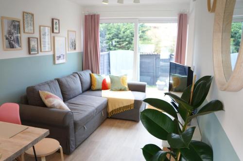 a living room with a couch and a table at The Oldbrook Garden Flat in Milton Keynes