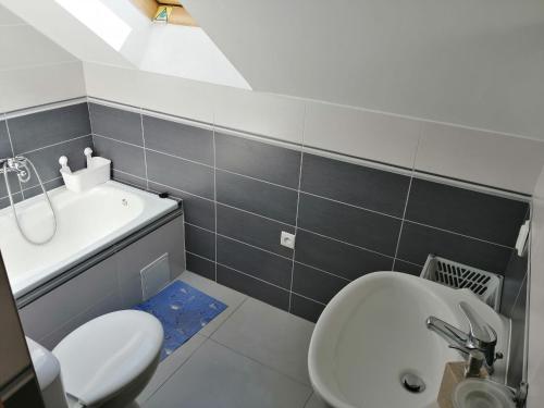 a bathroom with a white toilet and a sink at Baltic-House in Gąski