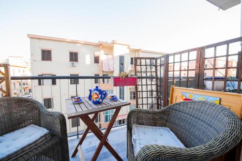 a balcony with two chairs and a table on a balcony at Casale D' Or in Palermo