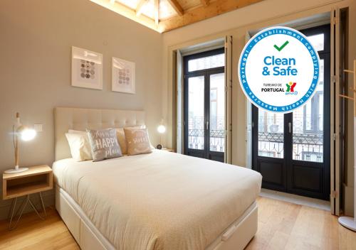 a bedroom with a bed and a sign that says clean and safe at LOFT Sá de Noronha in Porto