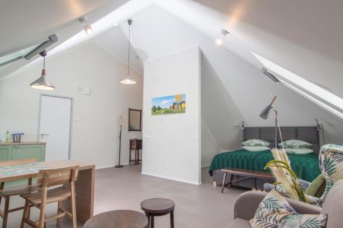 Cette chambre comprend un lit, une table et des chaises. dans l'établissement Käsmu Holiday House, à Käsmu