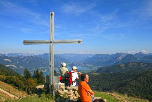 a group of people standing around a cross on a hill at Haus Hepi in Obertraun