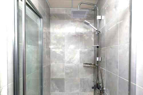 a shower with a glass door in a bathroom at Pera Boutique Hotel in Antalya