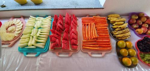 a display of fruits and vegetables in plastic containers at Hotel Brisas in Salinópolis