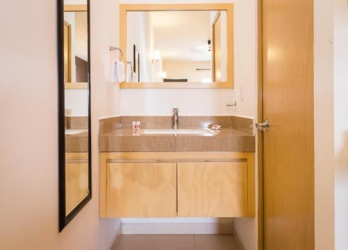 a bathroom with a sink and a mirror at Nova Hotel in Cadereyta Jim&eacute;nez