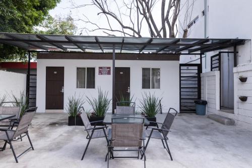 a patio with chairs and a table in front of a building at Nova Hotel in Cadereyta Jiménez