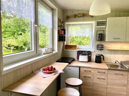 a kitchen with a sink and a bowl of fruit on a counter at DOMEK Dziki Sad Ustroń in Ustroń