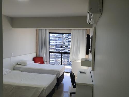 Cama o camas de una habitación en Brasilia Apart Hotéis