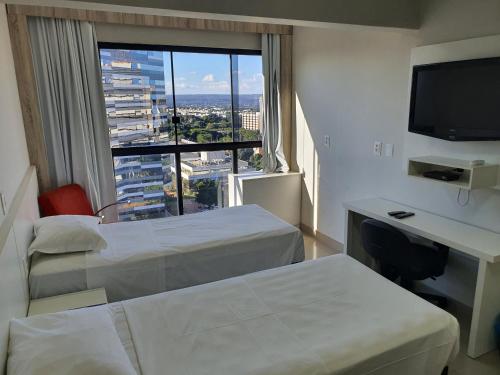 En eller flere senger på et rom på Brasilia Apart Hotéis