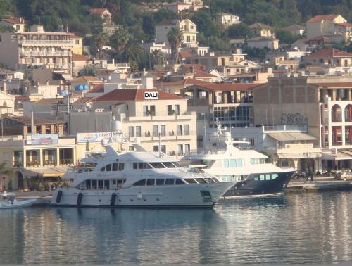 two boats docked in the water near a city at Dali in Zakynthos