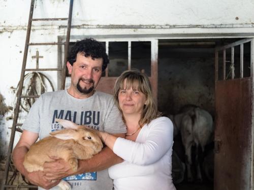 a man and a woman holding a rabbit at All'Ombra del Castello in Cigliè