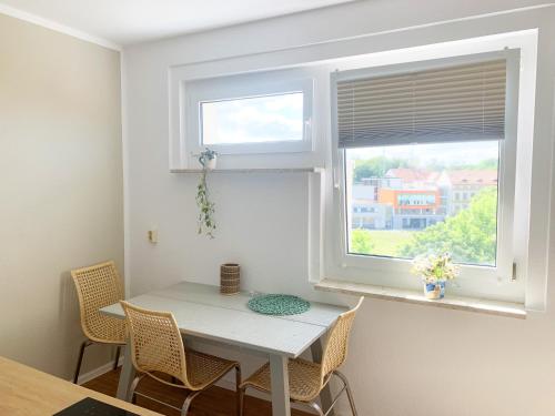 ein Esszimmer mit einem Tisch und einem Fenster in der Unterkunft Apartment Bella in Chemnitz