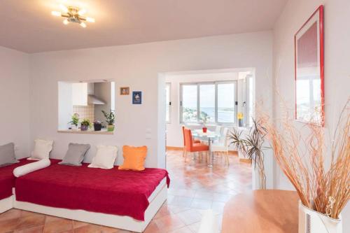 a bedroom with a red bed and a dining room at Apartment Jelka- center of Hvar town in Hvar