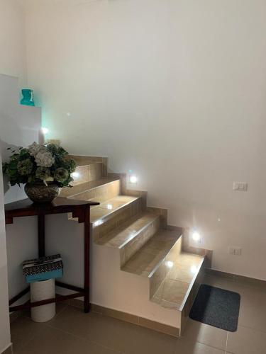 a staircase with a vase of flowers on a table at Casa Centru in Mediaş