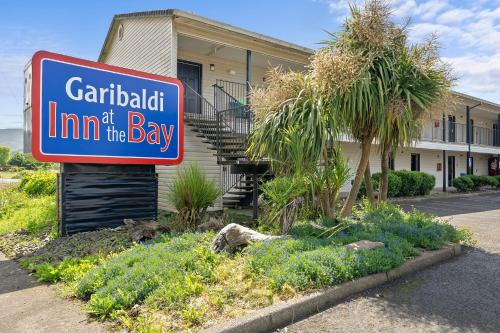a sign for a car rental inn of the day at Garibaldi Inn at the Bay in Garibaldi
