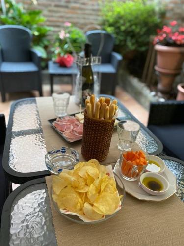a table with two plates of food and chips at B&B Le Campane in Ferrara