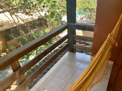 a porch with a hammock on a balcony at Vila Flores Pousada in Serra do Cipo