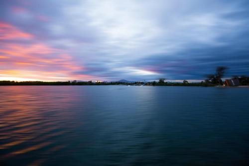 a view of a large body of water at sunset at Plana Resort & SPA in Castel Volturno