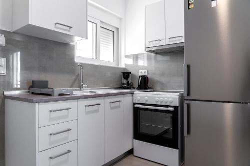 Η κουζίνα ή μικρή κουζίνα στο Aegean Horizon apartments
