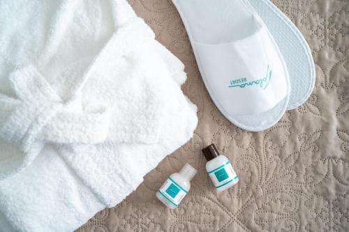 a bottle of hand sanitizer next to a towel at Plana Resort & SPA in Castel Volturno