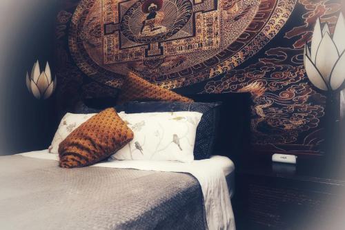 a bedroom with a bed with pillows and a wall at Whitsundays BNB Retreat in Airlie Beach