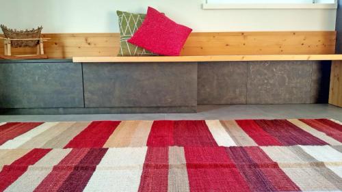 a room with a bench with a red pillow on it at Casa vacanze Heidi e Peter Val di Rabbi in Rabbi