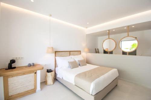 a white bedroom with a large bed and two mirrors at Aqua Blu "Adults Only" - "by Checkin" in Hersonissos