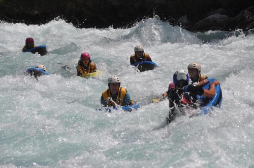 a group of people rafting in a river at La Foret De Maronne in La Garde